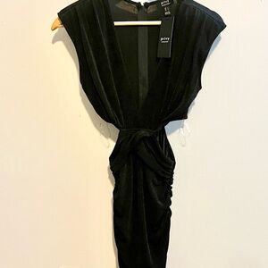 Privy knee length black dress with side cut outs, zip up back with ruching.